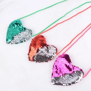 Three heart-shaped sequin mini purses for kids in green, red, and pink colors
