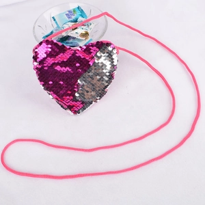 Detail of heart-shaped kids coin purse with reversible sequins and pink shoulder strap