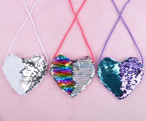 Detail of heart-shaped sequin mini bags with reversible flip patterns in multiple colors