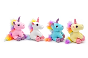 Row of four colorful plush unicorns in pink, white, blue, and yellow with rainbow manes