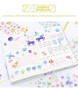 Detail showing decorative galaxy dolphin stickers applied on a notebook page