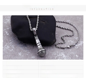 Macro detail of stainless steel microphone pendant necklace with rope chain and 33g weight