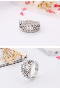 Detailed close-up of crown-shaped silver ring with sparkling white rhinestones and zircon