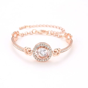 Detailed macro view of rose gold bracelet featuring central round zircon and pavé setting