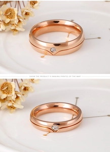 Detailed macro view of rose gold titanium rings with polished grooves and center zircon