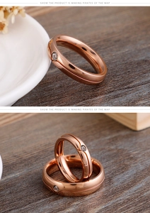 Macro view of rose gold titanium rings with a single diamond and central groove detail