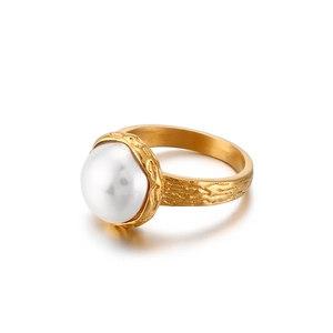 Golden shell titanium steel ring with white pearl and textured finish on white background