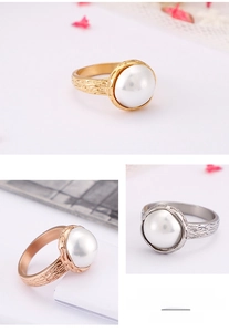 Detail of shell pearl rings in gold, rose gold, and silver with bark texture band