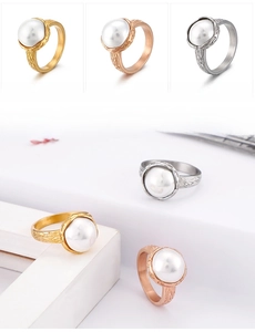 Detail view of shell pearl rings with textured bark finish in gold and rose gold