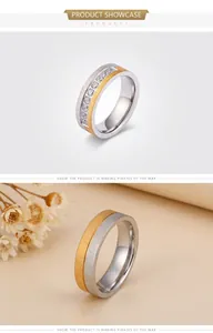 Close-up of brushed titanium rings featuring silver set stones and two-tone gold design