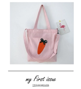 Pink canvas tote bag featuring carrot embroidery and adjustable shoulder strap detail