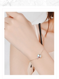 Close-up of elegant crown crown bracelet featuring iridescent moonstone on a silver chain