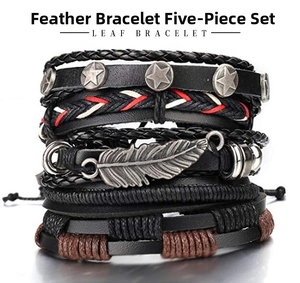 Close-up of five-piece vintage braided leather bracelet set with metallic leaf charm