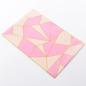 Flat view of pink and beige geometric triangle pattern biscuit packaging bag with gold lines
