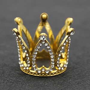Macro detail of a golden alloy crown with sparkling rhinestones on a dark textured background