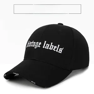 Close-up of black cotton baseball cap featuring white Vintage Labels gothic embroidery