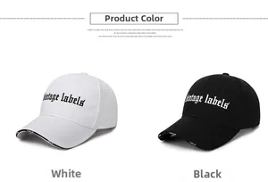 Detail of cotton baseball caps in black and white with gothic vintage labels embroidery