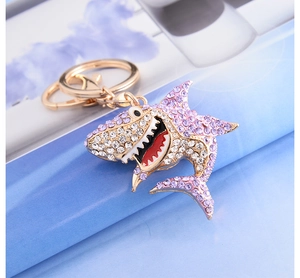 Macro shot of shark keychain featuring purple rhinestones and golden metal finish