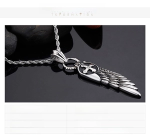 Macro detail of stainless steel angel wing cross pendant with fine feather texture