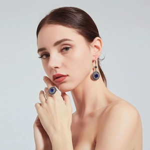 Detail showing vintage blue gemstone earrings and ring set with intricate engraving