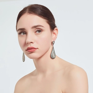 Detailed view of bohemian vintage silver drop earrings with blue and white crystals