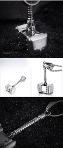 Macro detail of silver stainless steel Mjolnir hammer pendant with textured handle