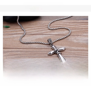 Detail of a minimalist stainless steel cross pendant necklace with product specifications
