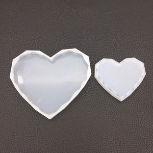 Macro detail of geometric heart-shaped silicone molds for DIY resin casting and crafts