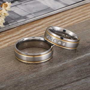 Brushed stainless steel couple rings in two-tone gold and silver with small diamonds