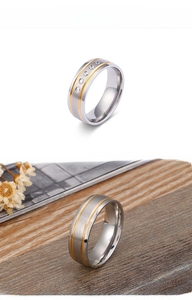 Detail of two-tone gold and silver stainless steel rings with brushed finish and diamonds