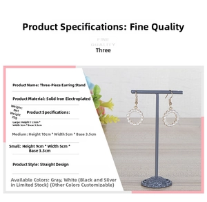 Three-piece solid metal earring stands with different heights on wooden surface