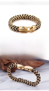 Detail of men's braided leather bracelet with 18K gold plated stainless steel clasp