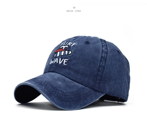 Detailed close-up of navy blue washed cotton baseball cap with Surf Wave embroidery