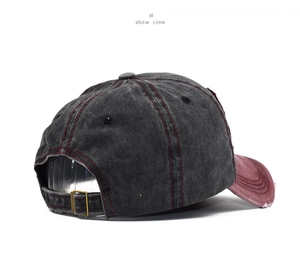 Detail view of washed vintage cotton baseball cap with contrast stitching and metal buckle