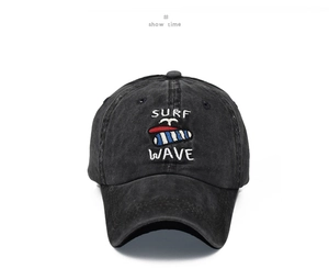 Detail of washed black cotton baseball cap with Surf Wave embroidery on a white background