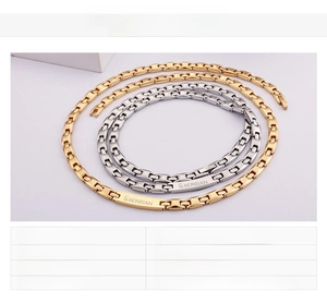Detailed view of 18K gold plated stainless steel chain with branded engraving on the clasp