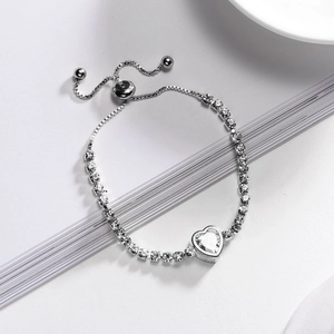 Detail of adjustable silver bracelet featuring a sparkling heart-shaped cubic zirconia stone