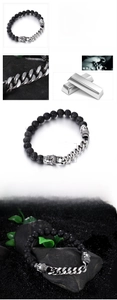Macro view of 8mm black lava stone beads and stainless steel buddha head bracelet
