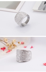 Macro shot of silver wide band ring with pave set round cubic zirconia stones