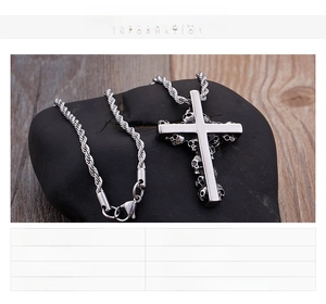 Detailed macro view of stainless steel cross pendant featuring engraved skull textures