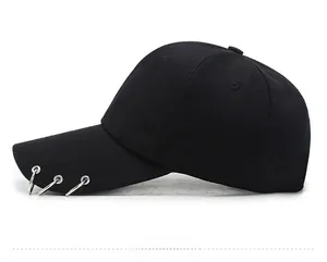 Detail view of black wool baseball cap featuring three silver metal rings on the brim