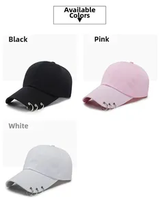 Detailed view of street style baseball caps in black, pink, and white with metal rings