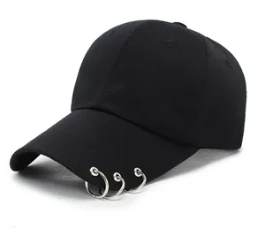 Detail of black wool baseball cap with three silver metal rings on the brim in street style