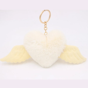 Detail of plush heart keychain with wings and gold metal clasp for bags