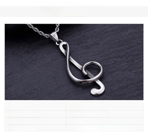 Detailed view of polished stainless steel treble clef musical note pendant with chain