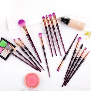 Detail of 15-piece makeup brush set with diamond-cut purple handles and rose gold tubes