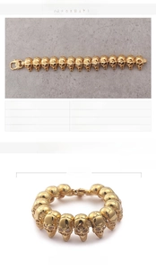 Detail view of gold stainless steel skull bracelet with 18K plating and zircon stones