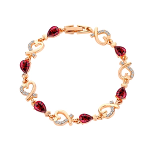 Elegant rose gold heart bracelet with red pear-cut stones and micro-pave zircons