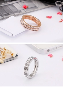 Macro detail of double-row pavé crystal rings in rose gold and silver stainless steel