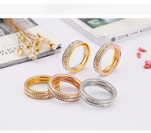 Close-up of double-row paved stone rings in gold, rose gold, and silver finishes